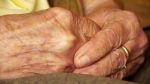 senior-old-woman-young-man-hold-hand-wrinkle-skin-close-up-36837150